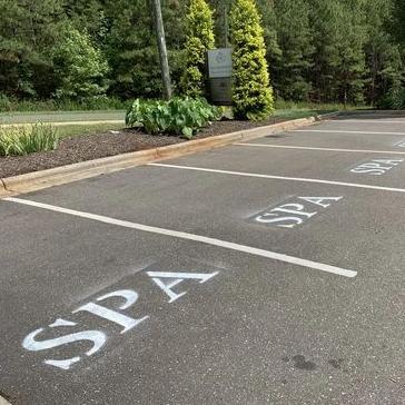 Custom parking lot stencil applied to a spa parking lot